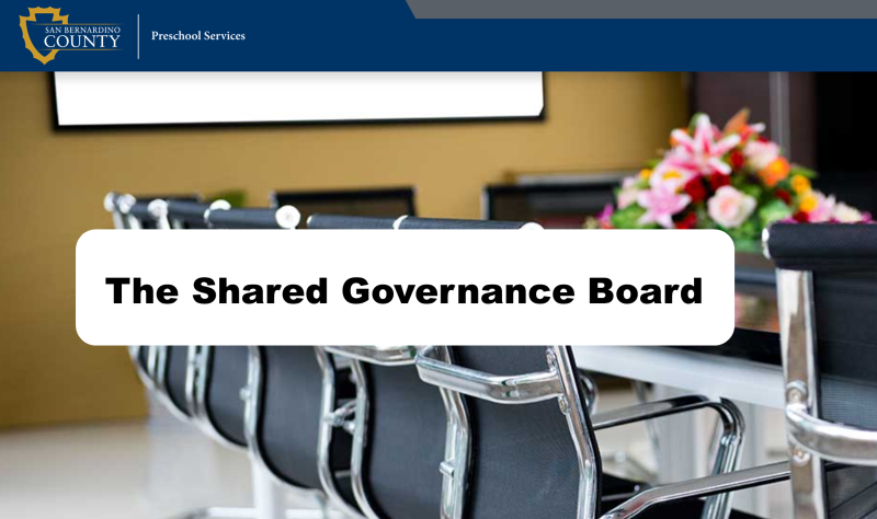 Confrence room table with flowers titled The Shared Governance Board